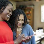 Mother and daughter using smart phone